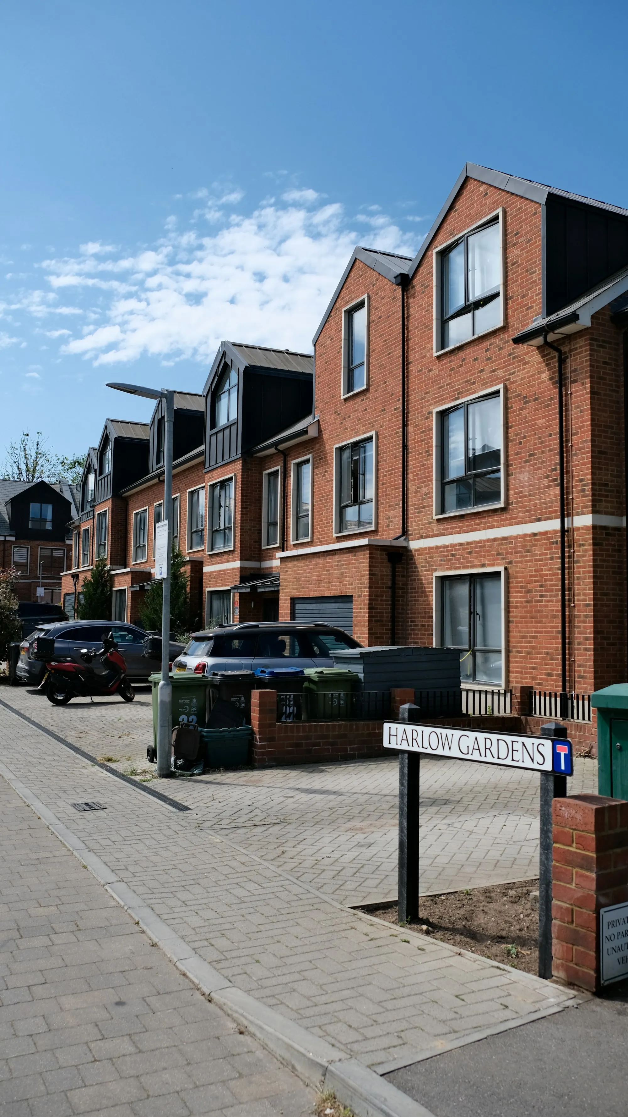 Residential street of brick townhomes on an overcast afternoon