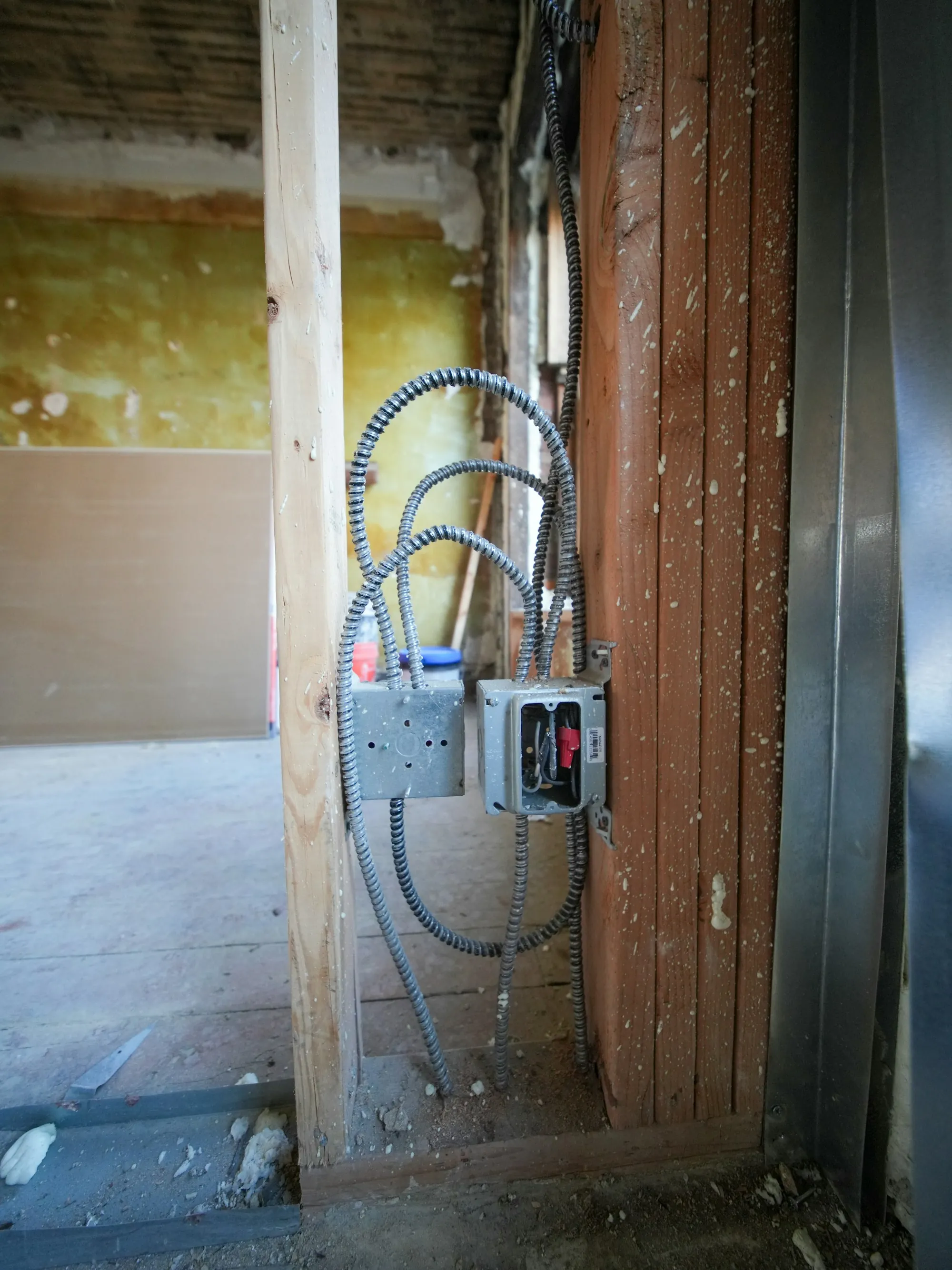 Neatly dressed conduit runs along a basement ceiling