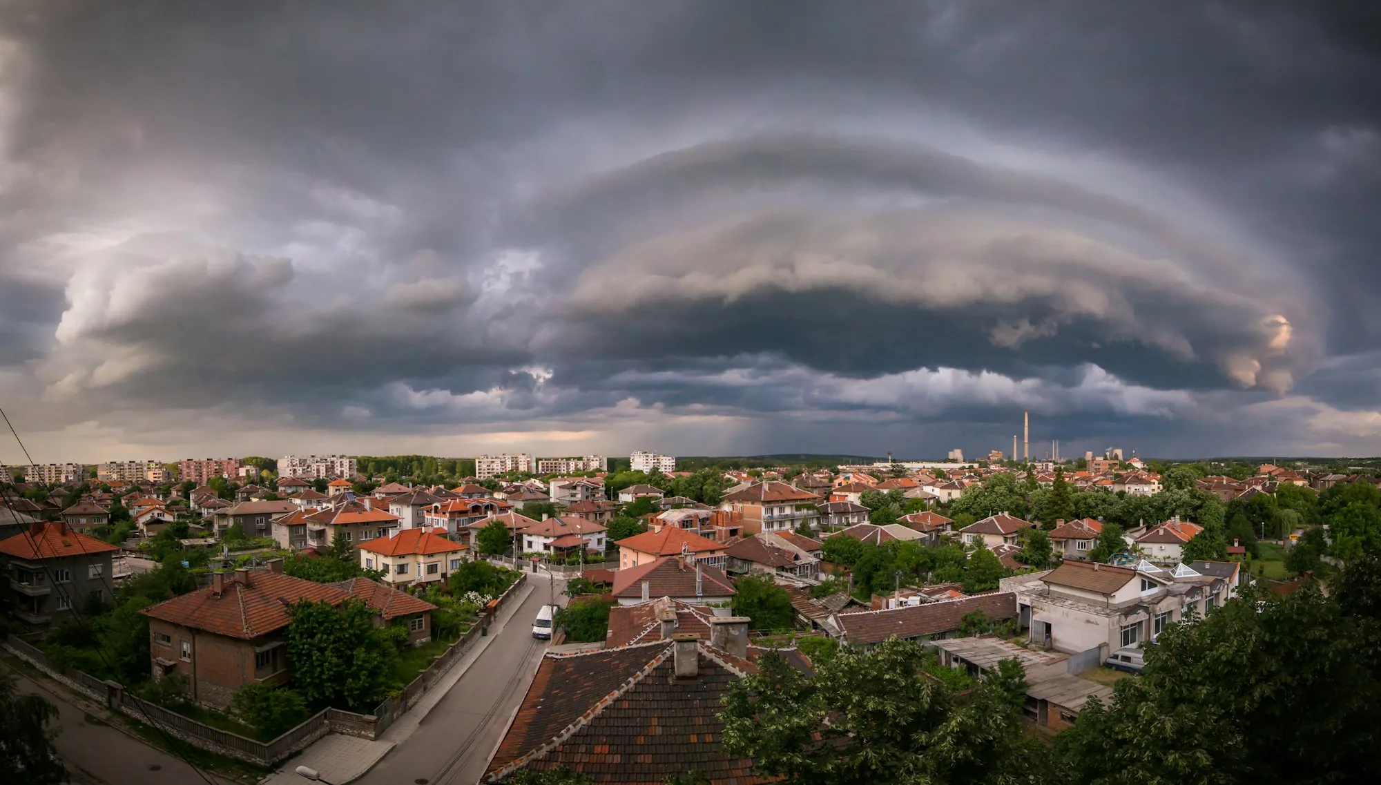 Storm clouds gathering over a suburban neighbourhood at dusk